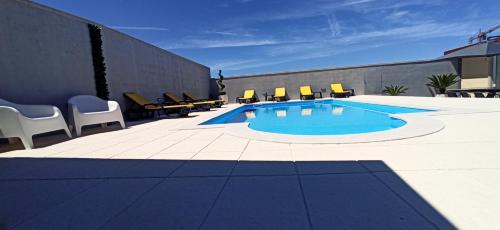 a swimming pool on the side of a building at Solar da Pedra in Paços de Ferreira