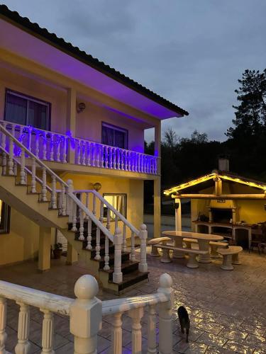 a house with a staircase and a cat in front of it at Villa Polina in Leiria