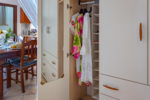 a kitchen with a closet and a dining room at Casa La Conchiglia in Sciacca