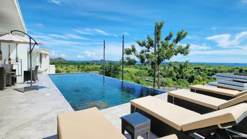 een villa met een zwembad met uitzicht bij PASSOT HILLS in Nosy Be
