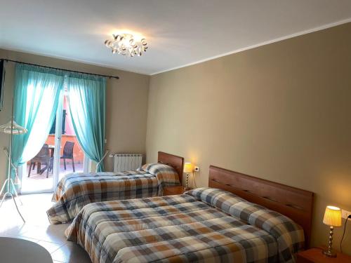 a bedroom with two beds and a chandelier at Green Quiet Affittacamere in Pignone