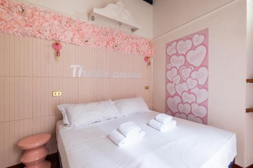 a small room with a bed with towels on it at maison Trevi in Rome