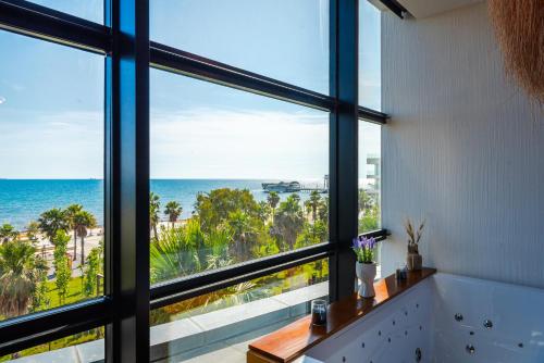 a bathroom with a large window overlooking the ocean at Marina Luxury Suites by PS in Durrës