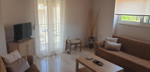 a living room with a couch and a table at Vaso Studios in Vathi, Ithaka