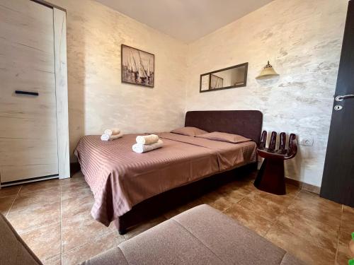 a bedroom with a bed with two teddy bears on it at Apartments Obradovic in Krasici
