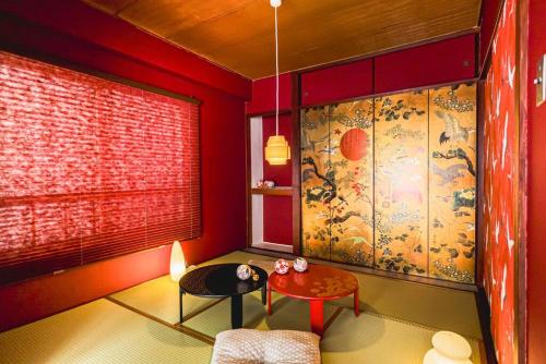 a red room with a table and a window at Akihabara Area! Direct to Shibuya, Narita, Haneda in Tokyo