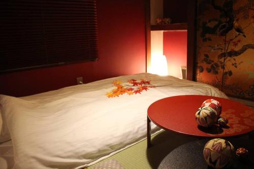 a red room with a bed with a red table and a bed with a red at Akihabara Area! Direct to Shibuya, Narita, Haneda in Tokyo