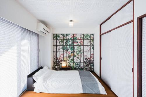a bedroom with a bed and a stained glass window at Akihabara Area! Direct to Shibuya, Narita, Haneda in Tokyo