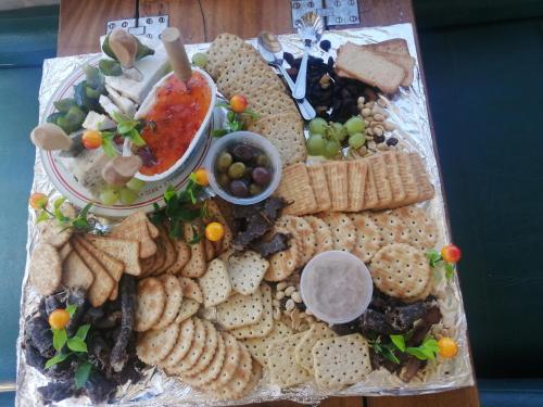 a platter of crackers and other snacks on a table at Kingfisher by the river - self catering in Velddrif