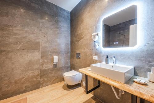 a bathroom with a sink and a toilet at Marina Luxury Suites by PS in Durrës