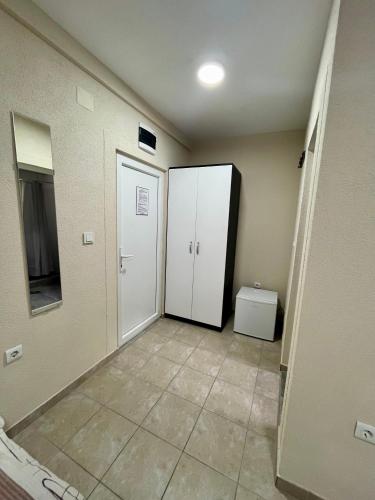 a hallway with two white doors and a toilet at Lux Ohrid in Ohrid
