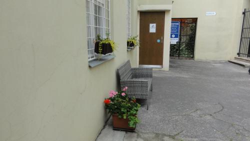 a bench next to a building with a potted plant at Penzion U Hradeb in Znojmo