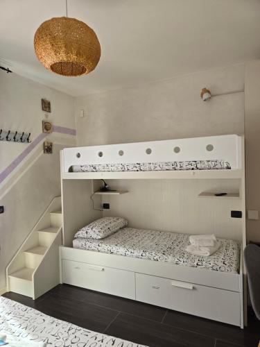 a white room with a bunk bed in it at Villa La Baia a pochi passi dal lago in San Felice del Benaco