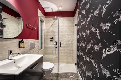 a bathroom with a shower and a toilet and a sink at Siesta Hotel Bakırköy in Istanbul