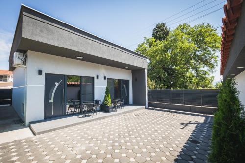 a patio with chairs and tables on a house at Sofia Luxury Apartments in Gevgelija