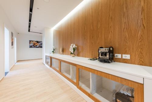 a hallway with a white counter and wooden walls at Marina Luxury Suites by PS in Durrës
