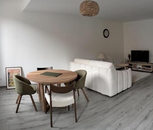 - un salon avec une table et un canapé blanc dans l'établissement La Provence vous Attend - 2ème étage, à Digne-Les-Bains