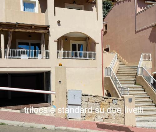 a building with stairs in front of a building at Appartamenti Shardana in Villasimius