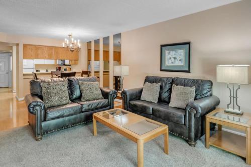 a living room with two leather couches and a table at Park Place Condos in Gatlinburg