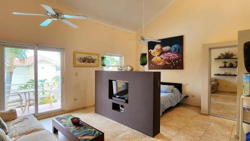 a living room with a tv and a couch at Ocean Dream 3d floor studio w/balcony in Cabarete