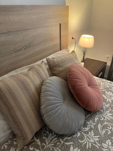 a bed with two pillows on top of it at Rincón de María - Ganador Traveller Awards 2025 y 2026 in Playa de Gandia