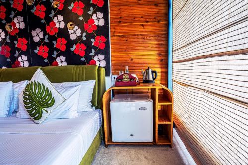 a bedroom with a bed with a night stand next to it at O2 Villas Ella in Ella