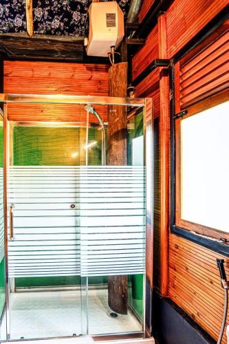 a glass shower in a room with a window at O2 Villas Ella in Ella