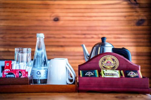 a tray with a tea kettle and a bottle of water at O2 Villas Ella in Ella