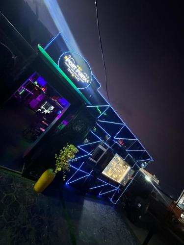 a bar with a neon sign and a counter at Port Punta in Lekki