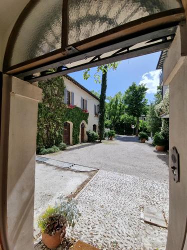 an open door to a driveway in a house at B&B Casa Zia Cianetta Residenza di Campagna in Capodacqua di Foligno