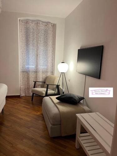 a living room with a couch and a chair at Casetta Mazzini in Rapallo