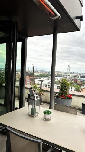 a table with a lantern on top of a building at Parliament House - Luxury Penthouse in London