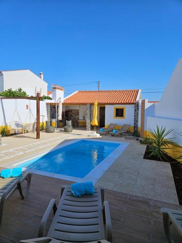 a villa with a swimming pool and a house at Ribeiros do Alqueva in Mourão