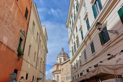 a building with a dome in the middle of a street at Domus Aurea Luxury Suites in Rome