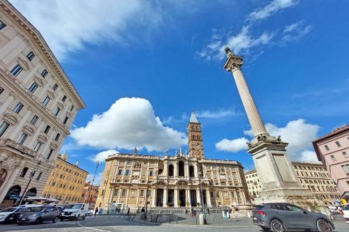 a large building with a statue in front of it at Domus Aurea Luxury Suites in Rome