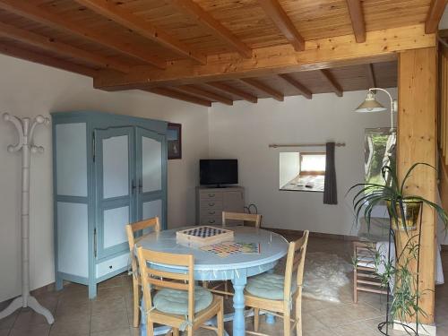 a dining room with a blue table and chairs at L'Abri du Berger in Olby