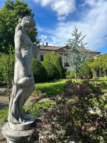a statue of a woman standing in a garden at Il Castello di Bubbio in Bubbio