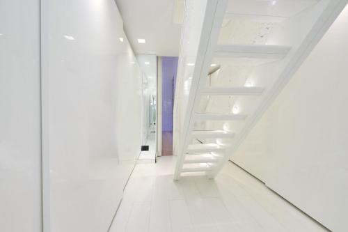 a hallway with white stairs in a white building at Domus Aurea Luxury Suites in Rome