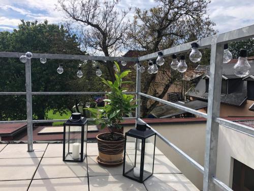 a balcony with several lights and a potted plant at Apartmány Jevany in Jevany
