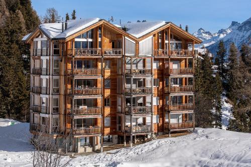 a large apartment building in the snow in the mountains at Haus Bella Vista in Riederalp