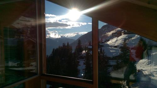 a window with a view of a snowy mountain at Haus Bella Vista in Riederalp