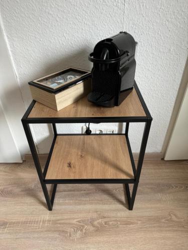 a table with a radio and a book on it at Günstiges Apartment Gelsenkirchen Schalke in Gelsenkirchen
