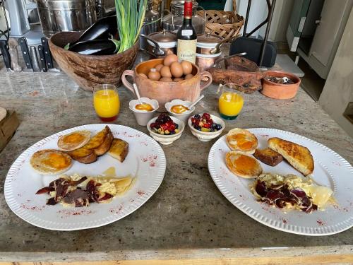 two plates of food on a counter with eggs and bread at L'Escampe in Saturargues