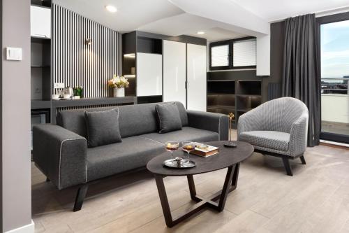 a living room with a couch and two chairs and a table at Siesta Hotel Bakırköy in Istanbul