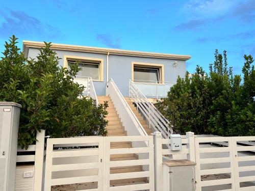 a staircase leading up to a house with a white fence at Le Terrazze della dolce casa - Blue Sky - Casa Vacanze a Marina di Ragusa in Marina di Ragusa