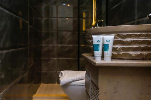 a bathroom with two cups on a counter next to a toilet at Crowne Pyramids View inn in Cairo