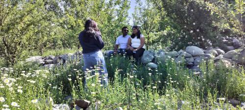 a group of three people standing in a field at Elizabeth paying guest house Tangmarg gulmarg in Gulmarg