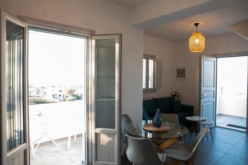 a living room with a glass table and chairs at Golden View Suites in Vóthon