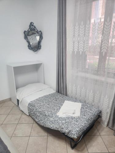 a small bed in a room with a window at B&B Regina Margherita in LʼAquila