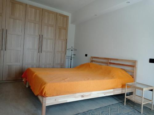 a bedroom with a large bed with wooden cabinets at Casa vacanze Archero in Dronero